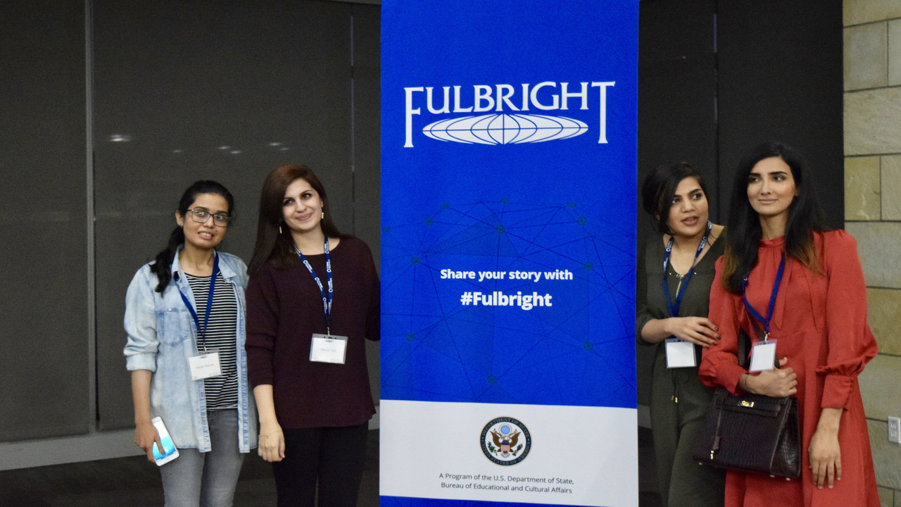 students pose with Fulbright banner