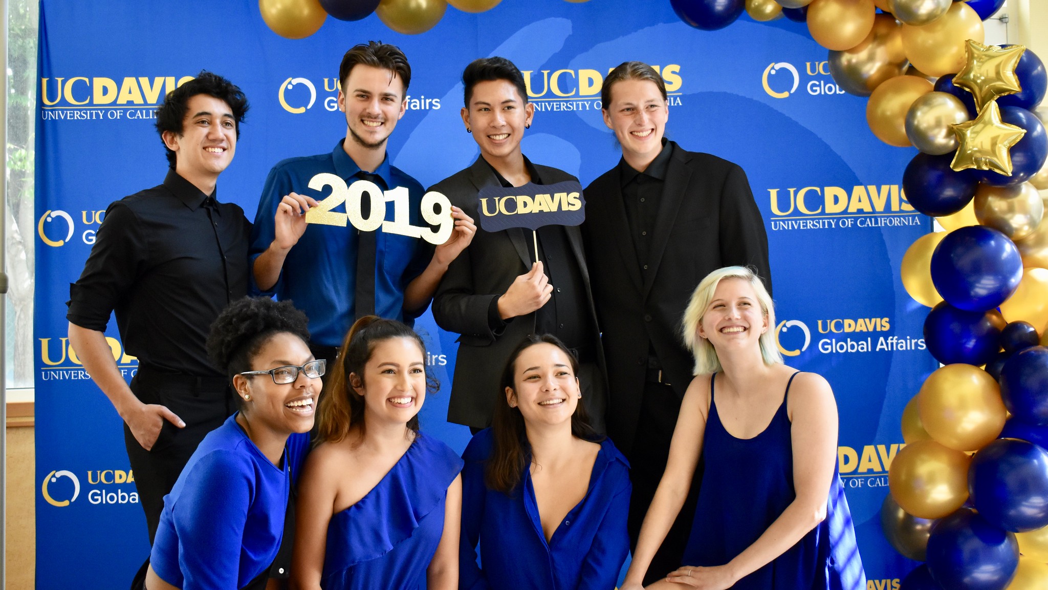 a group of kids in front of a backdrop