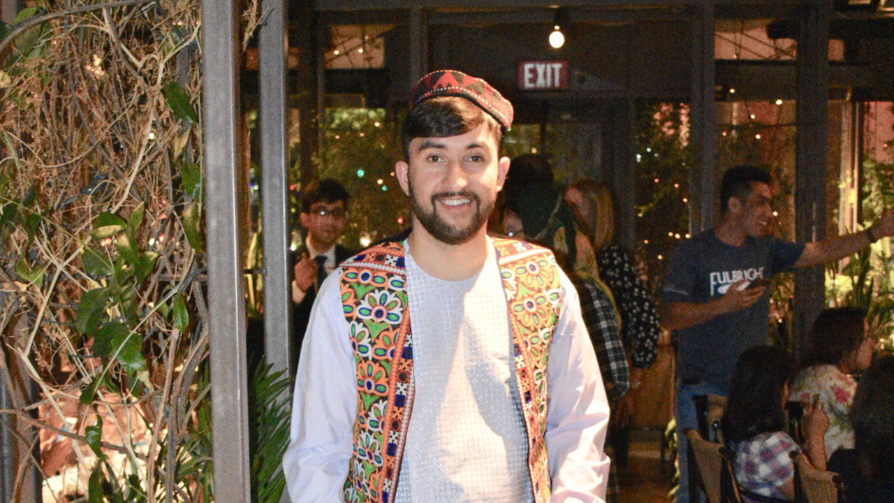 student poses in traditional clothes