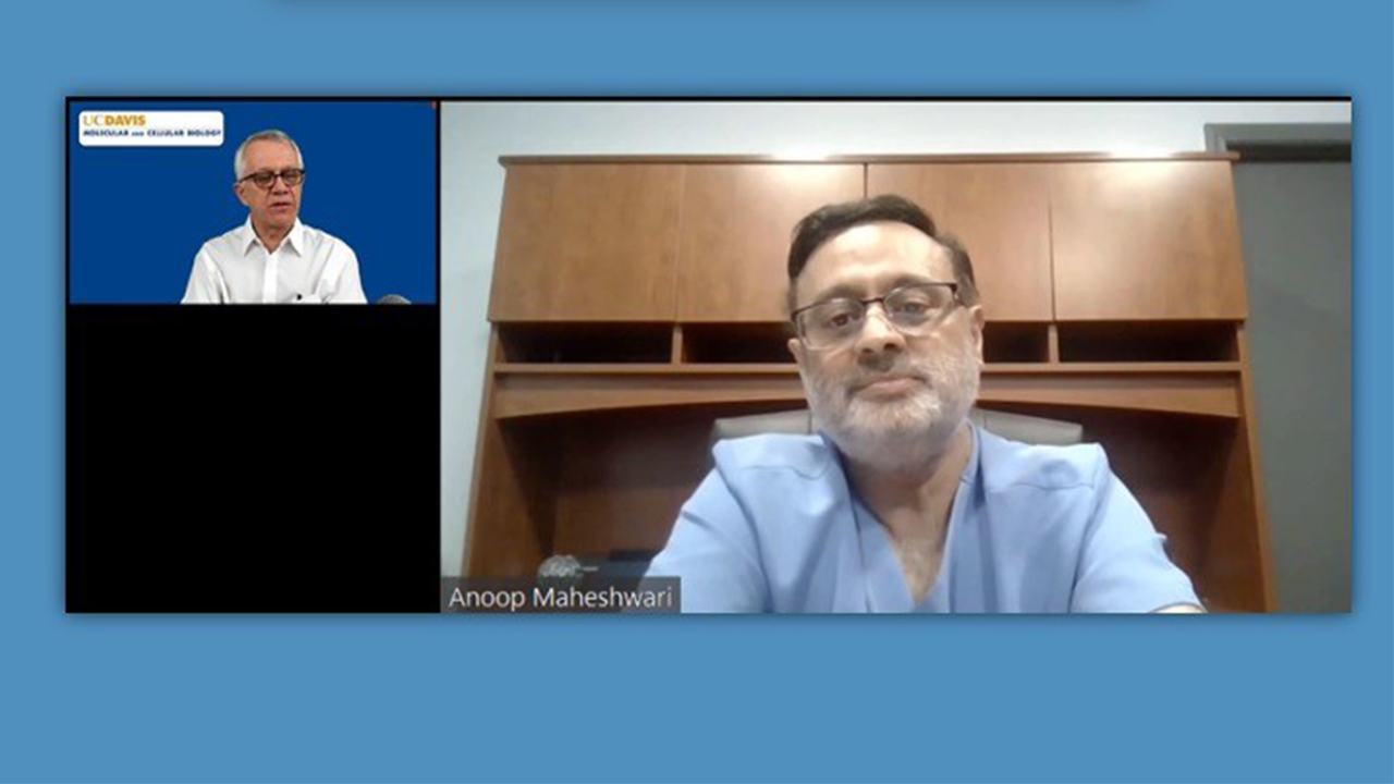 Leal and guest on screen during symposium