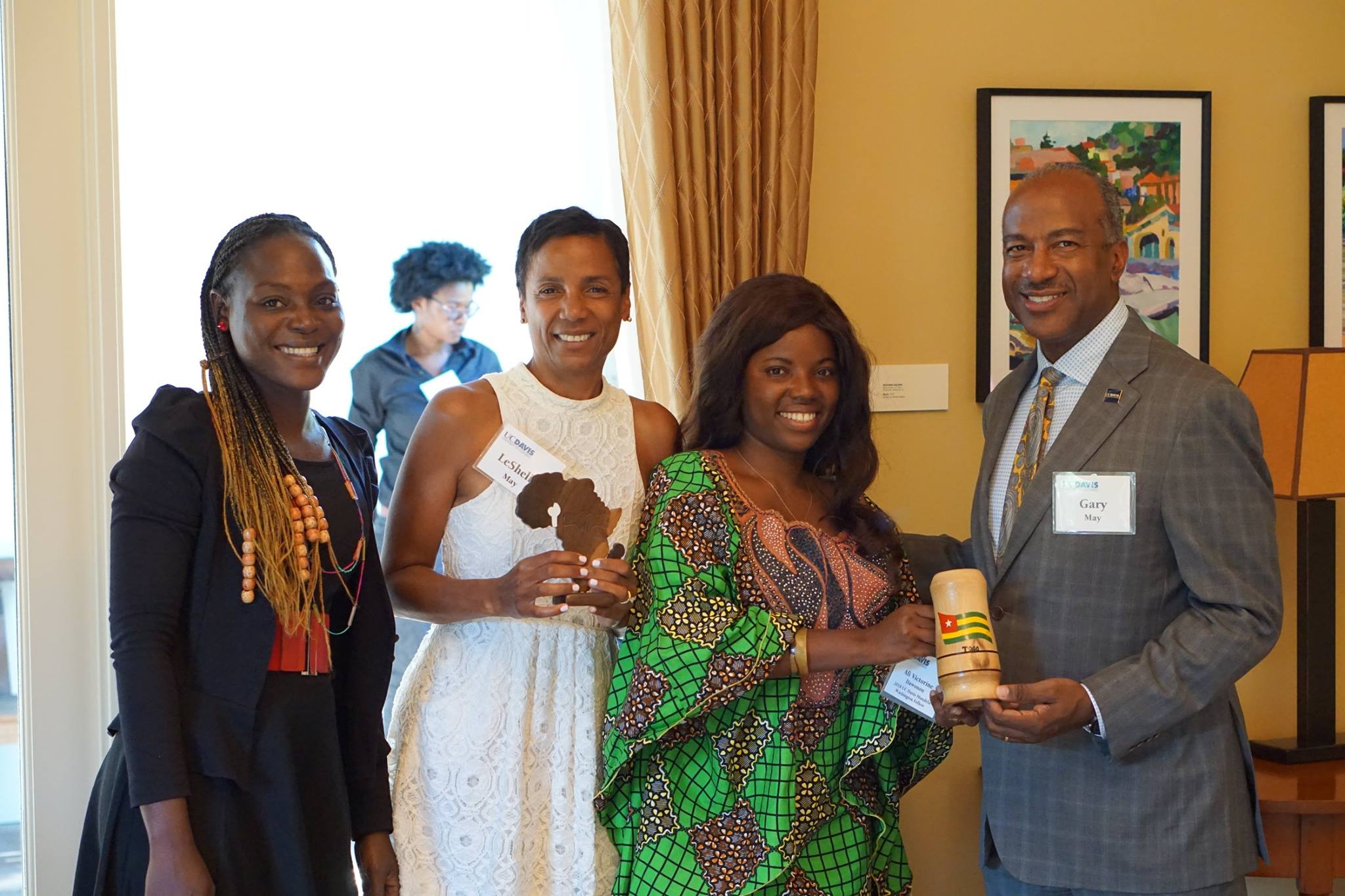 Two fellows with Chancellor Gary May and LeShelle May