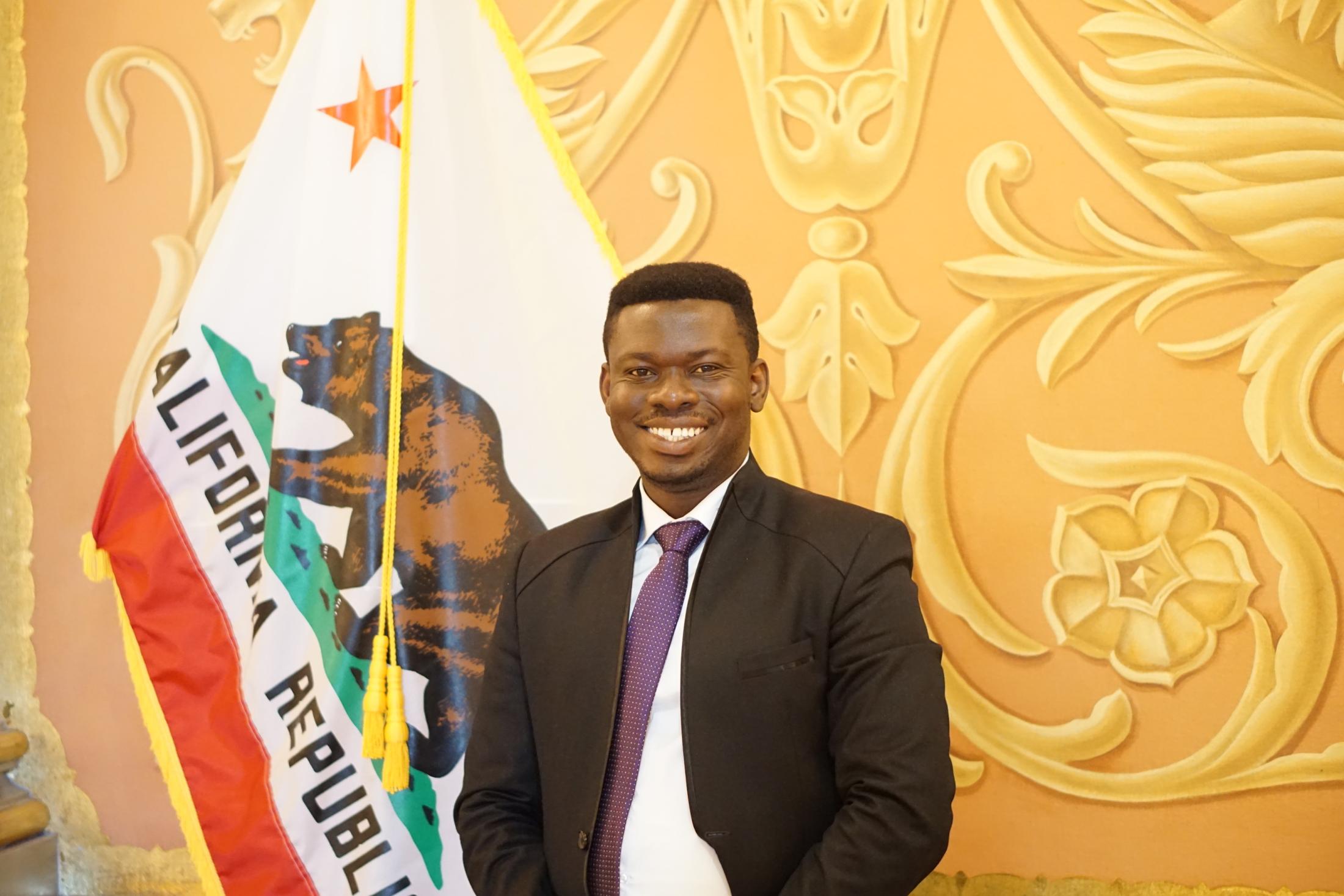 Mandela Fellow in front of California flyer
