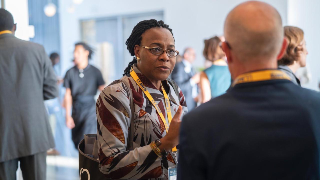 Rutgers University Professor Oussenia Alidou, a conference speaker, continuing conversations during a conference networking reception. Karin Higgins/UC Davis. Rutgers University Professor Oussenia Alidou