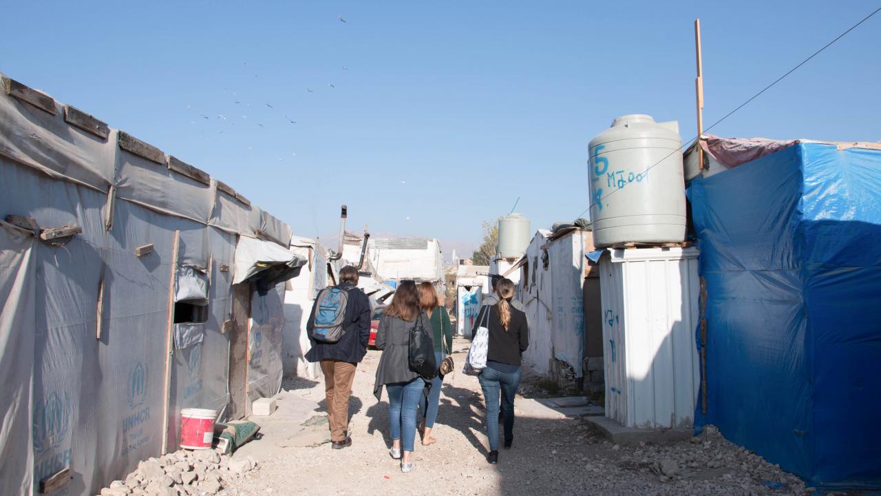 Dr. Watenpaugh and Backpack Guide student volunteers walk through the Jarahiyyah refugee camp in the Biqa' Valley. Watenpaugh with student volunteers