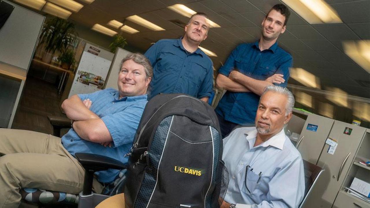 Among those who worked on the technology for Article 26 Backpack are, from left to right, Shawn DeArmond, web architect; web developers Carson Black and Jeroen Post; and project manager Erie Comer. (Karen Higgins/UC Davis) IET professionals with backpack