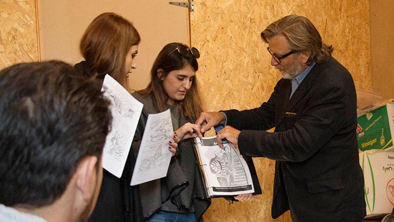UC Davis professor Keith David Watenpaugh, right, and two trained guides from the American University in Beirut use a comic book to explain Article 26 Backpack at a refugee camp in Lebanon as Jihad Qusanyeh looks on. (Liz McAllister/UC Davis) Professor Watenpaugh in Lebanon