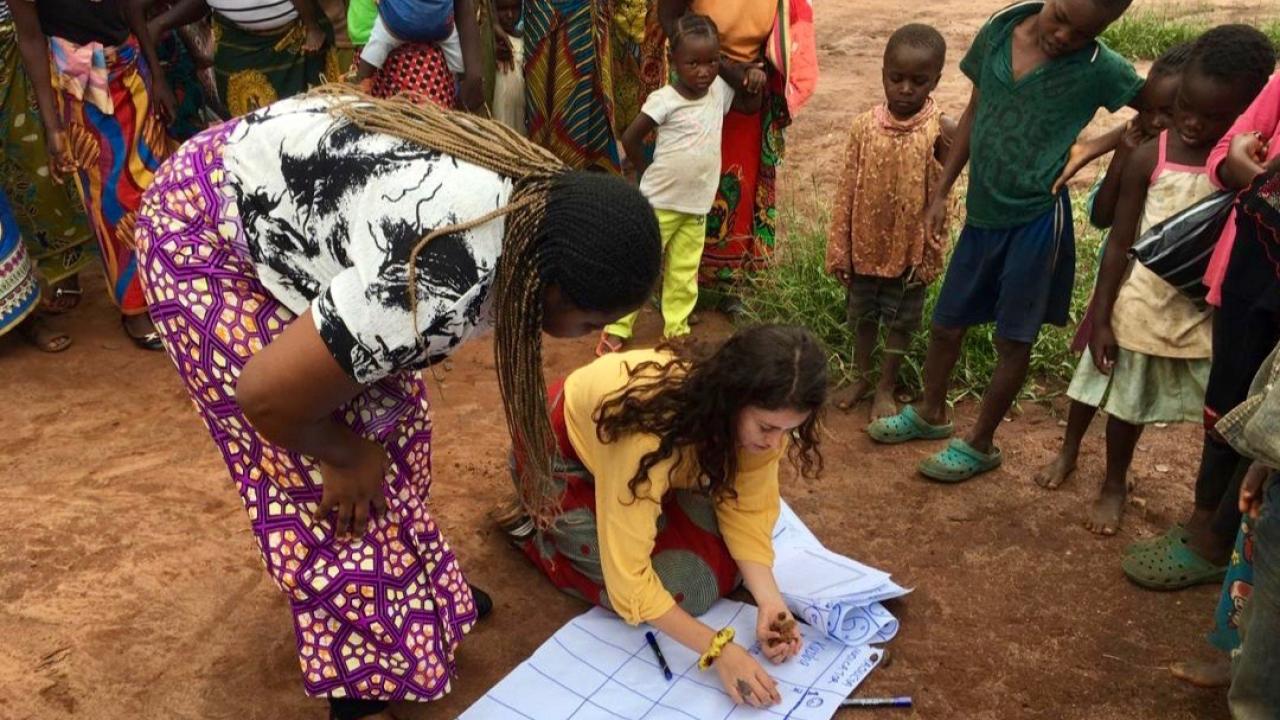 UC Davis alumna Whitney Galindo, kneeling, serves as a community health educator in Zambia. (Courtesy photo) UC Davis alumna and current Peace Corps volunteer Whitney Galindo (center) serving as a community health educatorin Zambia.