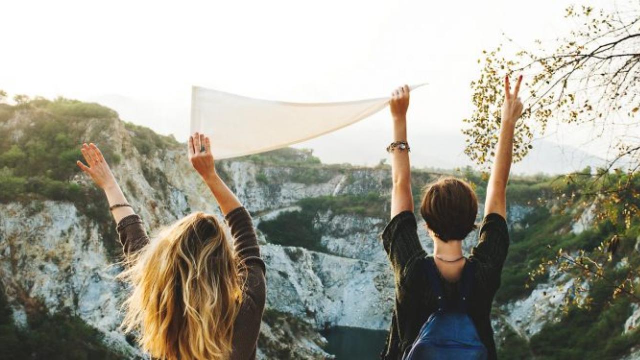 "We want 100% of our students by the time they graduate...to have some form of global and intercultural engagement". Photo: Pexels People with arms in air