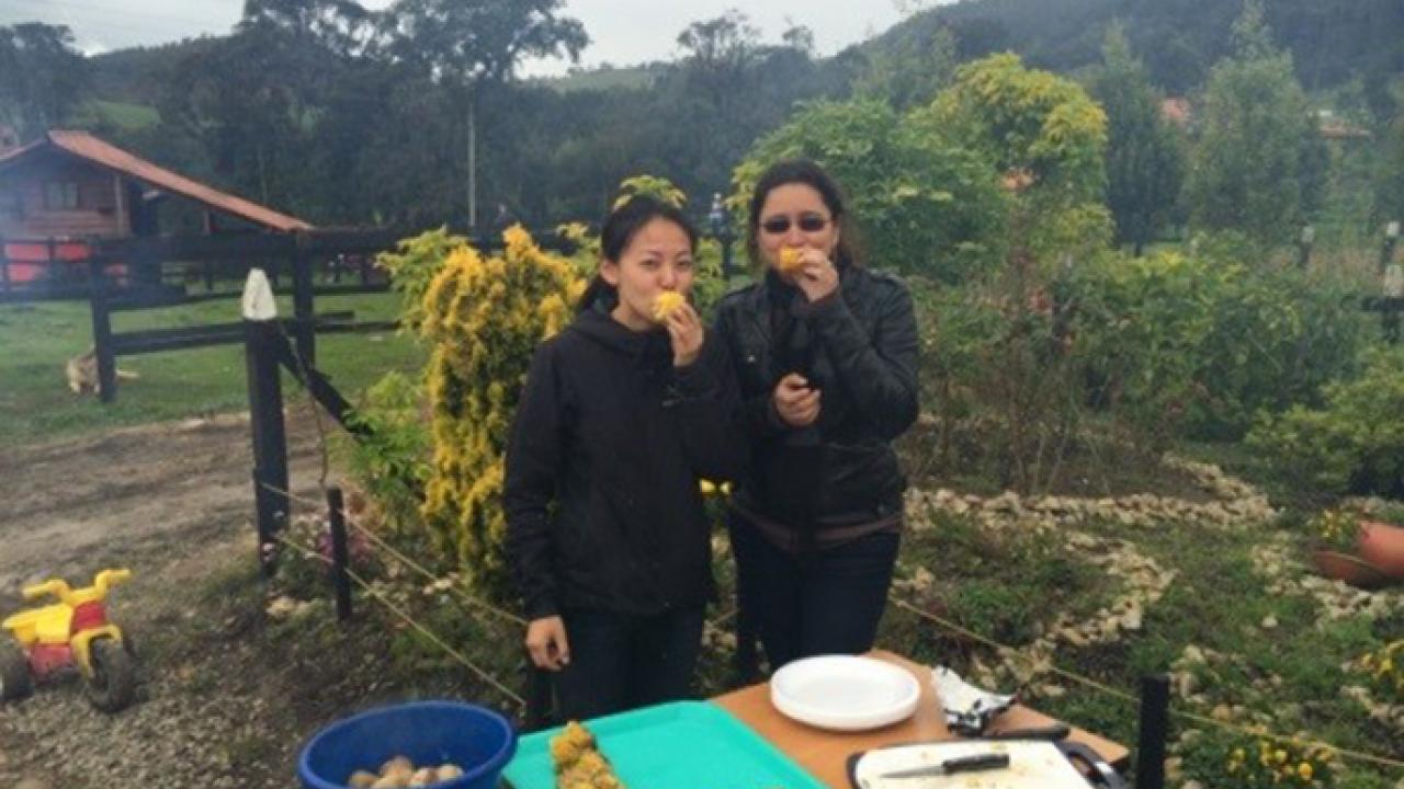 During her 2015 USAID fellowship in Colombia to assess environmental impacts of intensified agriculture in grasslands, Meiling Gao (left) of UC Berkeley enjoys an outdoor barbecue with colleague Juliana Hernández. USAID Fellow in Colombia