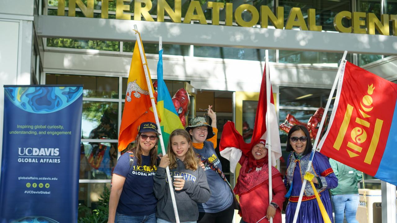 UC Davis Picnic Day parade participants holding international flags